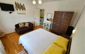 a living room with a bed and a couch at 1 Bedroom Cozy Apartment In Vrbnik in Vrbnik