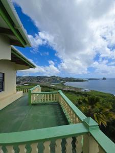 a balcony of a house with a view of the ocean at Ocean Heights in Arnos Vale +12 photos