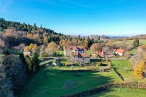 an aerial view of a large house in a field at Chambres d'hôtes La Marche des Bois in Crocq
