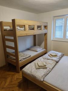 two bunk beds in a room with a window at Apartmán Matěj in Poděbrady
