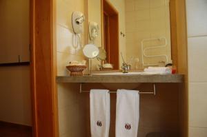 ein Badezimmer mit Waschbecken, Spiegel und Handtüchern in der Unterkunft Casa Da Fonte in Algarvia + 33 Fotos