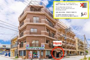 een gebouw met een bordje waarop staat hier bij Naha Gajumaru Apartment Hotel 401 in Naha +42 foto's