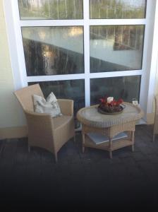 a room with two chairs and a table and a window at Ferienwohnung Haus Anja In Bad Füssing in Bad Füssing