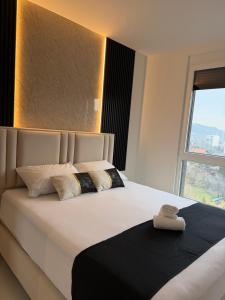 Ένα ή περισσότερα κρεβάτια σε δωμάτιο στο Avenija-Otoka