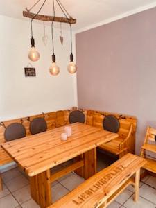 a dining room with a wooden table and chairs at Lieblingsplatz in Petersdorf auf Fehmarn