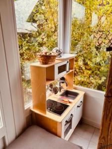 a small kitchen with a stove and a window at Lieblingsplatz in Petersdorf auf Fehmarn +11 photos