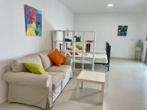 a living room with a couch and a table at Geysotur Torrox Playa Apartamentos in Torrox