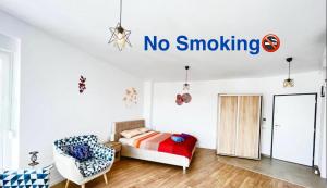 a bedroom with a bed and a no smoking sign on the wall at Apartment Mara 1 in Timişoara