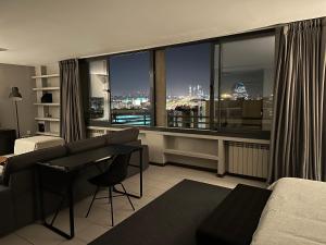 a bedroom with a large window with a view of a city at Lujoso Loft La Moraleja in Madrid +75 photos