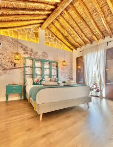 a bedroom with a large bed in a room at Recuerdos del Sur in El Gastor +59 photos