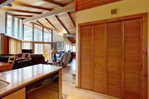 a kitchen and living room with a large wooden closet at Home in the Pines in Munds Park +17 photos