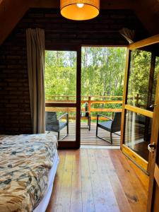 a bedroom with a bed and a view of a deck at La Rubina in Villa Ventana