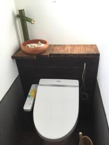 a bathroom with a toilet with a remote control at Strawberry Villa - Vacation STAY 17858 in Ichihara