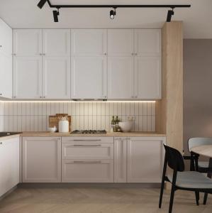 une cuisine avec des armoires blanches et une table dans l'établissement House with furniture and new kitchen, à Alatskivi