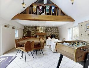 a living room with a table and a chess board at Moulin Harry 21 pers : 10 min Viaduc de la Souleuvre in Le Tourneur