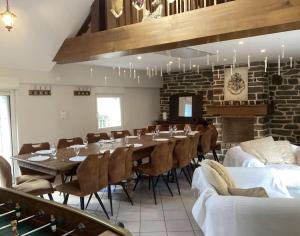 a dining room with a long table and chairs at Moulin Harry 21 pers : 10 min Viaduc de la Souleuvre in Le Tourneur +26 photos