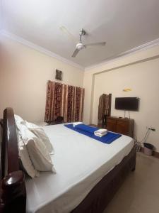 a bedroom with a large bed with a ceiling fan at HOTEl BOMMANA RESIDENCY in Godāvari