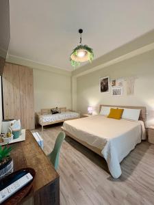 a bedroom with a large bed and a desk at Favola Guesthouse Affittacamere in Nettuno