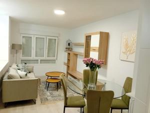 a living room with a glass table and chairs at El Rincon de Riera in Pola de Lena