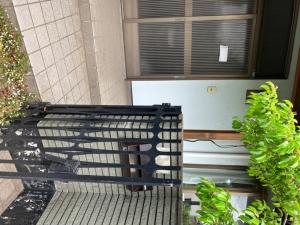 a black bench sitting in front of a window at Strawberry Villa - Vacation STAY 16883 in Ichihara +22 photos
