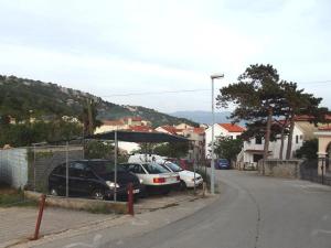 a group of cars parked in a parking lot at Studio In Einem Traditionellen Steinhaus, In Baska in Baška +6 photos