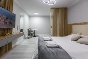 a bedroom with a large bed and a desk at Zoris Apart1 in Bacău