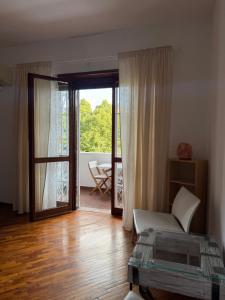 a living room with a bed and a sliding glass door at Alam B&B Bologna in Bologna