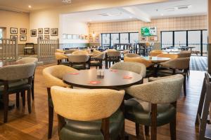 a dining room with tables and chairs at Pairc House Hotel in Birmingham