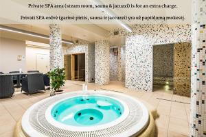 a jacuzzi tub in the middle of a room at VICTORIA Hotel Kaunas in Kaunas