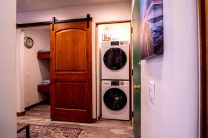 a laundry room with a washer and dryer next to a door at Sun Valley Condo 123 in Ketchum