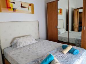 a bedroom with two beds and a mirror at VV 68 Secretario Artiles in Las Palmas de Gran Canaria