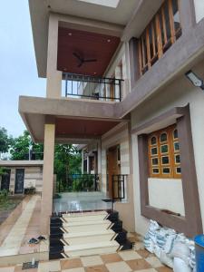 a house being remodeled with a balcony at Vasant Vihar Farm House in Silvassa