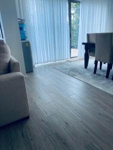 een woonkamer met een houten vloer en een piano bij NK Plaza in Nairobi