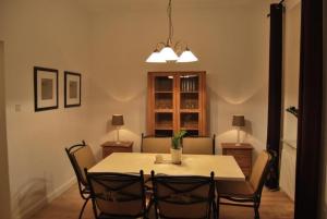 a dining room with a table with chairs and a light at City Fewo Stricker in Bad Sachsa