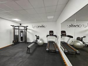 a gym with several treadmills and weights in a room at Long Vita in Przewóz