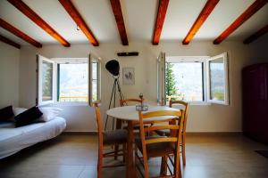 a living room with a table and chairs and windows at Villa Mima in Kotor +47 photos