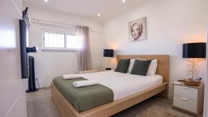 a bedroom with a large bed and a window at KS near the airport in Lisbon