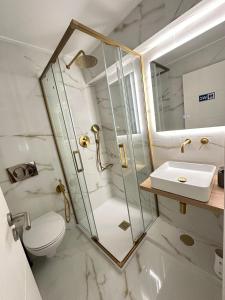 a bathroom with a shower and a toilet and a sink at KS near the airport in Lisbon +75 photos