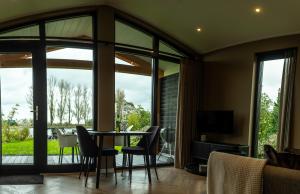 a living room with a table and chairs at Rijn Residentie in Alphen aan den Rijn