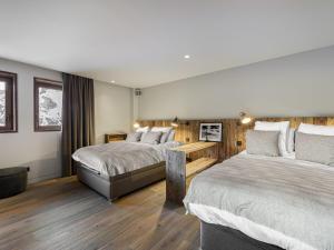 a hotel room with two beds and a couch at Chalet skis aux pieds avec bain nordique, 12/14 pers, chef inclus - FR-1-570-3 in Saint-Martin-de-Belleville