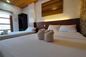 Ένα ή περισσότερα κρεβάτια σε δωμάτιο στο Taj Guesthouse Boracay