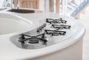 a stove top oven sitting on top of a counter at Seaview Penthouse 2 in Alnmouth +6 photos