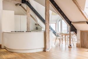 a kitchen with a bathtub in the middle of a room at Seaview Penthouse 2 in Alnmouth