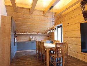 a kitchen and dining room with a table and chairs at Apartmánový Dom Terchová in Terchová