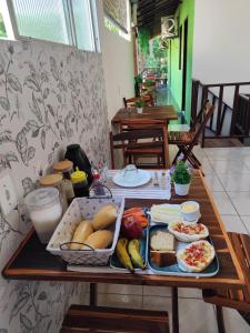 a table with a tray of food on it at Pousada Horizonte in Ilha de Boipeba