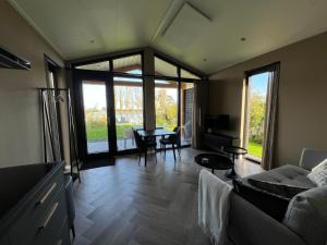a living room with a couch and a table at Rijn Residentie in Alphen aan den Rijn