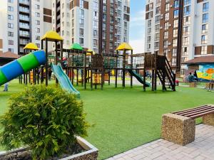 a playground with a slide in a park at New chisinau in Chişinău