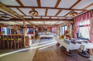 a dining room with tables and chairs in a building at Konak Koliba in Leskovac