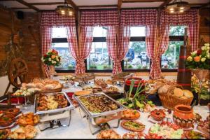 a buffet with many different types of food on a table at Konak Koliba in Leskovac +16 photos