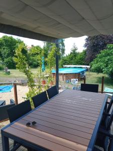 a wooden table with chairs in a yard at la thiberienne du Nord in Thiviers